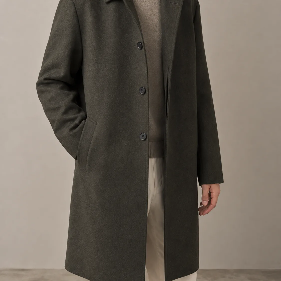 Charcoal olive city coat shown on a cropped model without a visible face.